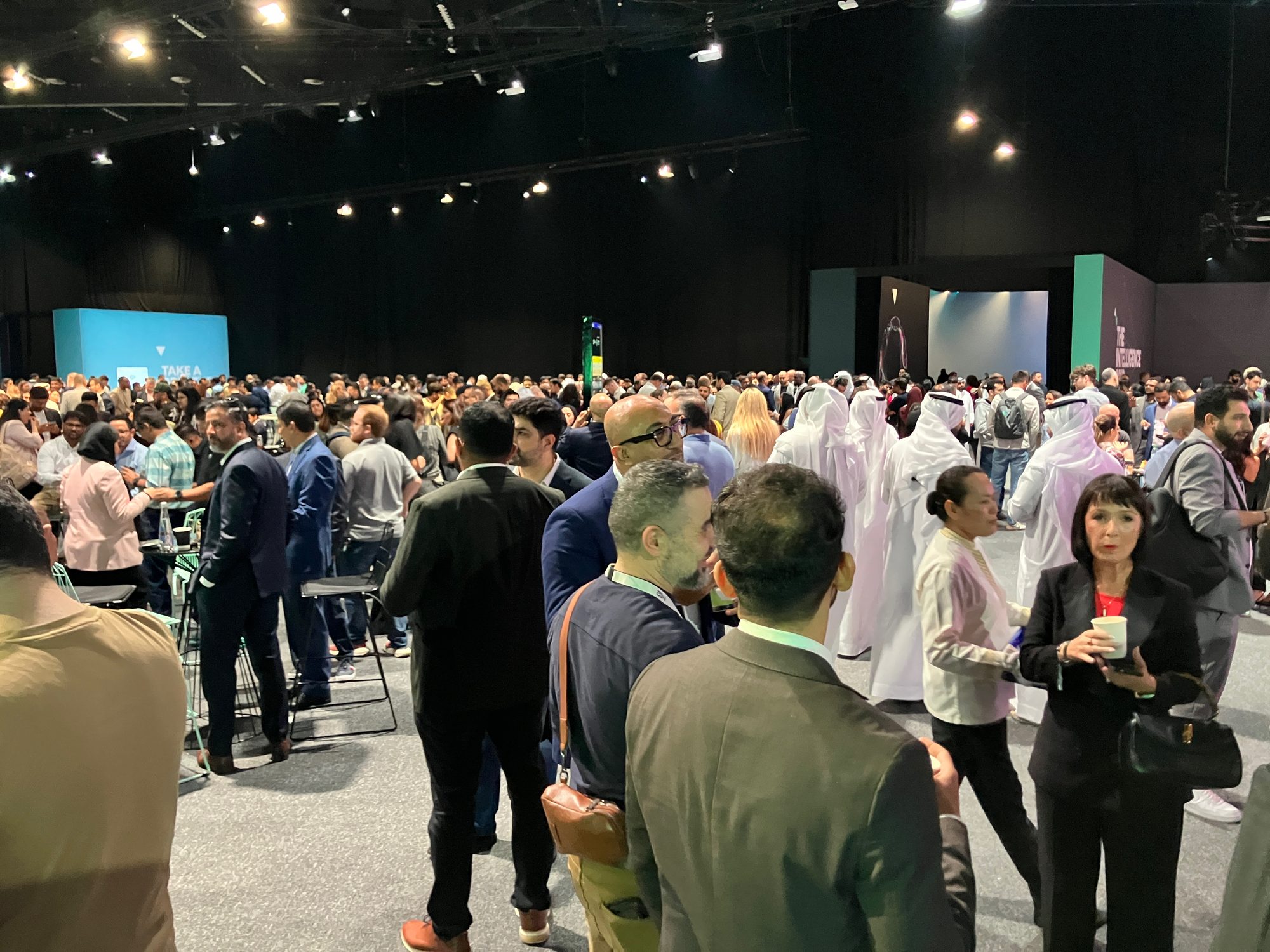 A dense crowd of delegates mingling in the hall between sessions